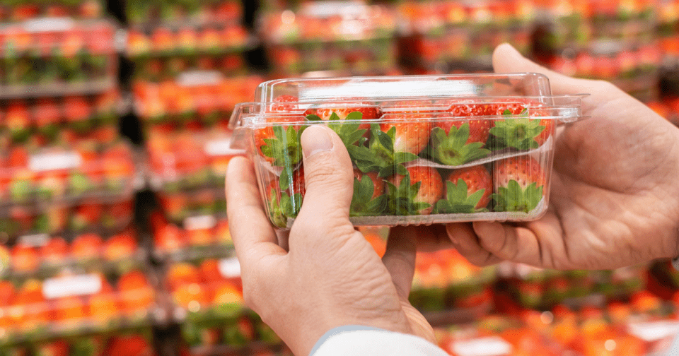 Image of hands holding a strawberry container